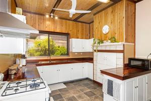 a kitchen with white cabinets and a window at Our Humble Home Nannup in Nannup +19 photos