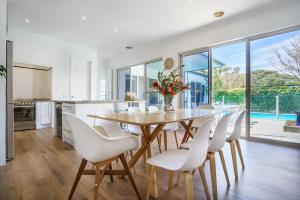 a kitchen and dining room with a table and chairs at The Portsea Hideaway in Portsea