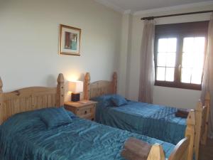 a bedroom with two beds and a window at Apartment on The Beach Front with Free Fibre Internet and Air Conditioning in Isla Canela