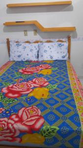 a bed with a flower pattern on the floor at Apart hotel em Caldas Novas in Caldas Novas +12 photos