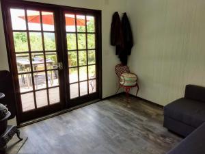 a living room with a door and a chair at Catskills tiny house cabin in Livingston Manor