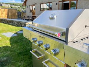 a barbecue grill sitting on top of a yard at Bod Eithin in Harlech