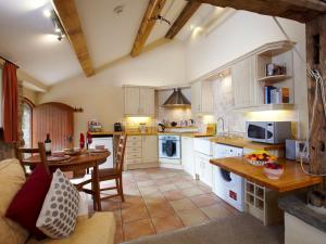 a large kitchen with a table and a dining room at Bramble Cottage - Uk4186 in Hazlehead Bridge