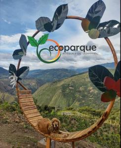 a dog sitting in a wooden hammock with a plant at Ecoparque in Buesaco