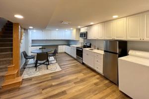 a kitchen with white cabinets and a table with chairs at Cozy Home for Family & Friends Gathering in Beaverton