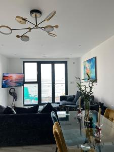 a living room with a couch and a glass table at Royal View in Ramsgate