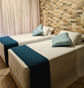 two beds sitting next to each other in a room at La Casa Greeff Guesthouse in Pretoria