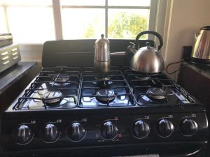 a stove top with a tea kettle on top of it at Pretty house Bastimentos Bocas del toro in Bastimentos