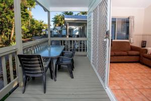 a balcony with a table and chairs and a couch at BIG4 Tasman Holiday Parks - Ballina in North Creek