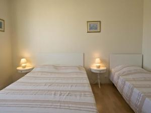 - 2 lits dans une chambre avec 2 lampes dans l'établissement Appartement Les Sables-d'Olonne, 2 pièces, 5 personnes - FR-1-92-639, à Les Sables-dʼOlonne