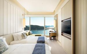 a hotel room with a bed and a large window at The Fullerton Ocean Park Hotel Hong Kong in Hong Kong
