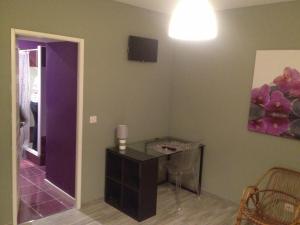 a room with a table and a painting on the wall at Appartements d'hôtes Santa Giulia in Niort