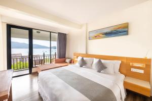 a hotel room with a bed and a balcony at Bubu Resort in Perhentian Island