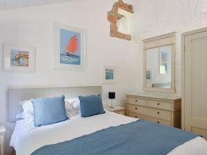 a bedroom with a bed and a dresser and a mirror at Farm Cottage - Ukc4056 in Nancledra
