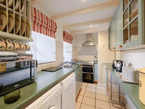 a large kitchen with a counter and a stove at Farm Cottage - Ukc4056 in Nancledra