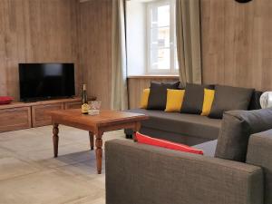 a living room with a couch and a coffee table at Gîte Arlempdes, 5 pièces, 8 personnes - FR-1-582-107 in Arlempdes