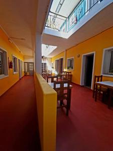 an empty room with tables and chairs and a skylight at Hotel dyd in Necochea