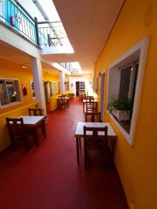 a hallway with tables and chairs in a building at Hotel dyd in Necochea