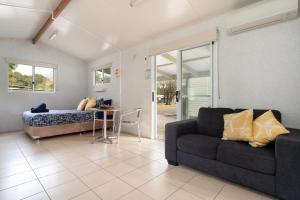 a living room with a couch and a table at Tasman Holiday Parks - Myola in Myola