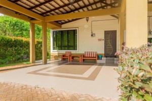 a patio with a wooden table and chairs on it at 5 Bedrooms Homestay with Private Pool (SEROJA) in Nilai