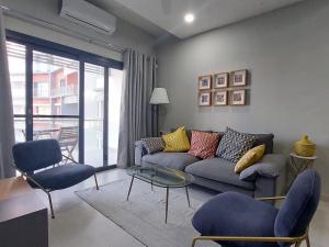 a living room with a couch and a table and chairs at Superbly Modern and Airy Two Bedroom Seaside Apartment with Balcony in Bijilo +34 photos