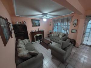 a living room with two couches and a fireplace at Amplia y Hogareña Casa in Aguascalientes