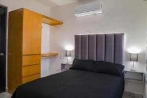 a bedroom with a bed and a wooden cabinet at Planta Baja, a 10 minutos de la playa, Gran alberca y Mini Golf!! in Mazatlán +72 photos