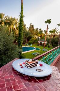 a piece of cake on a plate on a table at Double room in a charming villa in the heart of Marrakech palm grove in Marrakesh