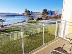 a balcony with a view of the water at Strandhotel S33-103 in Heiligenhafen