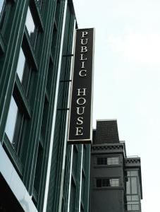 a hotel sign on the side of a building at Public House Bangkok, a Member of Design Hotels in Bangkok