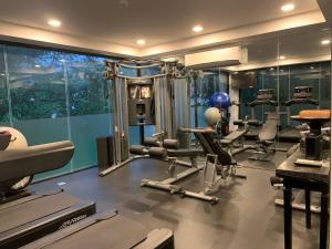 a gym with a bunch of equipment in a room at Bensley Collection Pool Villas - Shinta Mani Angkor in Siem Reap