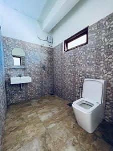 a bathroom with a toilet and a sink at Leisure Mount Villa in Haputale