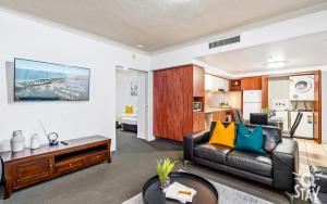 a living room with a couch and a table at 2 Bedroom 1 Bathroom Apartment - Centre of Surfers Paradise, Chevron Renaissance in Gold Coast
