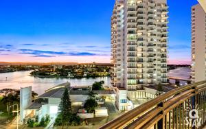 a view of a large apartment building at dusk at 2 Bedroom 1 Bathroom Apartment - Centre of Surfers Paradise, Chevron Renaissance in Gold Coast