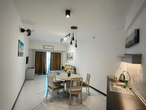 a kitchen and living room with a table and chairs at Paradise by the Sea in Penang by Veron at Rainbow Paradise in Tanjung Bungah