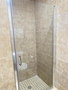 a shower stall with a glass shower door at City Center Motel in Oxnard