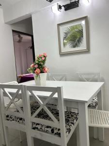 a white table and chair with a potted plant on it at Homestay Putrajaya , Icha Homestay Presint 9 in Putrajaya