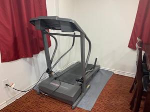 a treadmill is sitting on the floor in a room at Guest House Room No 01 in Mississauga