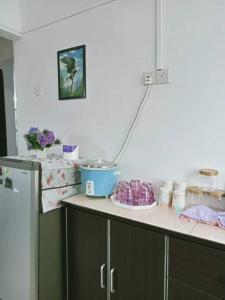 a kitchen with a counter top with a refrigerator at Homestay Putrajaya , Icha Homestay Presint 9 in Putrajaya