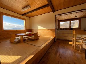 a room with a table and a large window at Tamanegi House luxury 4 bedroom Ski Chalet in Nozawa Onsen