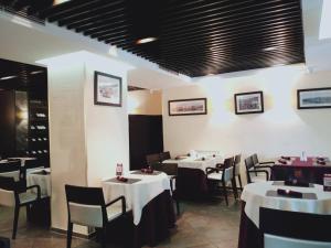ein Esszimmer mit weißen Tischen und Stühlen in der Unterkunft Urgoo hotel in Ulaanbaatar