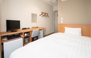 Postel nebo postele na pokoji v ubytování Kur and Hotel Isawa
