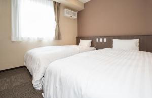 Postel nebo postele na pokoji v ubytování Kur and Hotel Isawa