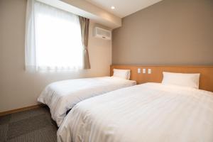 Postel nebo postele na pokoji v ubytování Kur and Hotel Isawa
