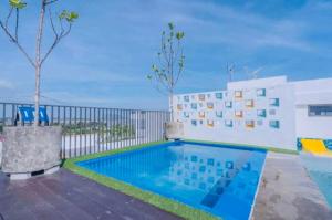 a swimming pool in front of a building at Imperio Armanistay Alor Star in Alor Setar