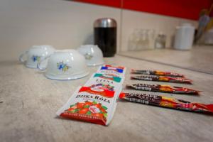 a counter with toothbrushes and a packet of candy at Centrum red apartament in Wałbrzych