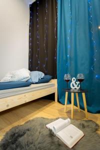 a bedroom with a bed and a blue curtain at Centrum red apartament in Wałbrzych
