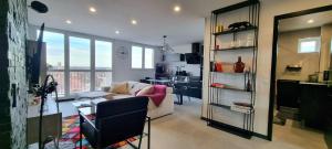 a living room with a couch and a table at Le Perchoir, High-end & Panoramic View in Troyes