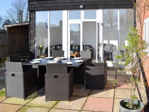 a patio with a table and chairs in a yard at Riverside in Stalham