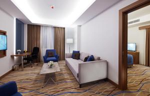 a living room with a couch and a table at Dedeman Kayseri in Kayseri